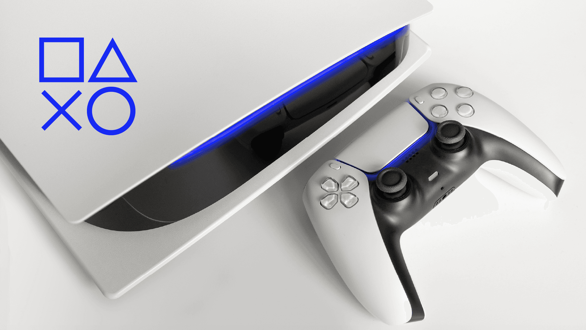 image of a silver video game console and controller